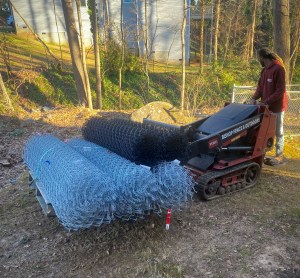 Dingo delivering chain link fence